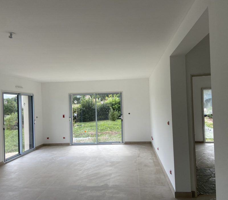 Freshly painted white interior with large windows and tiled flooring